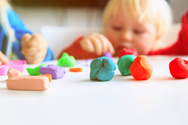 istock kids play with clay molding shapes 1011645504
