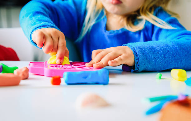 istock Child playing with clay molding shapes 1011645520