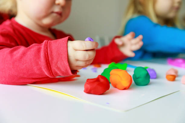 istock kids play with clay molding shapes 1011645556