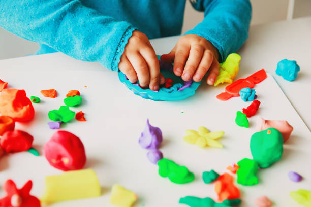 istock Child playing with clay molding shapes 1011645592
