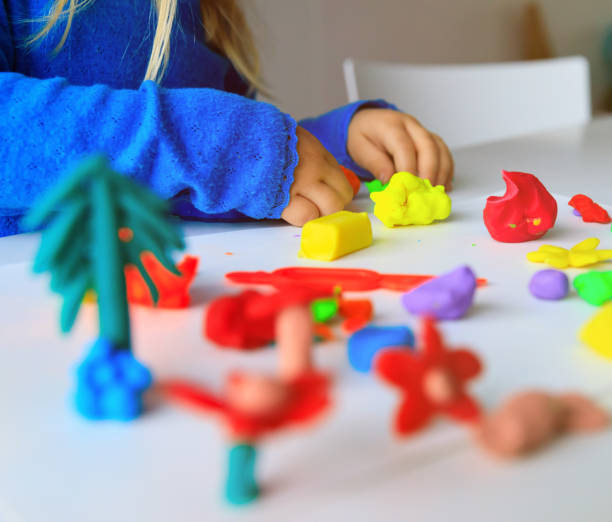 istock Child playing with clay molding shapes 1011645618