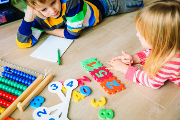 istock little boy and girl learn to write and calculate numbers 1011645652