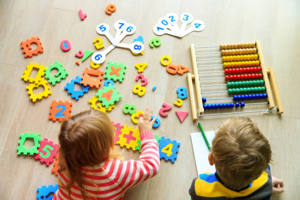 istock little boy and girl learn to write and calculate numbers 1011645682