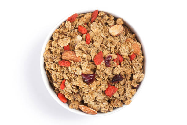 istock Close up Granola on white bowl isolated on white background. 1011647996