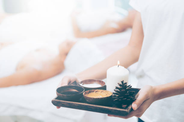 istock Massage therapist with hot spa treatment set. 1011654188