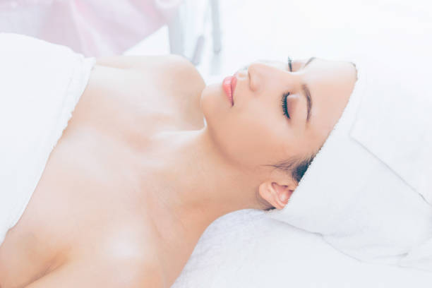 istock Relaxed young woman lying on spa bed for massage. 1011654338