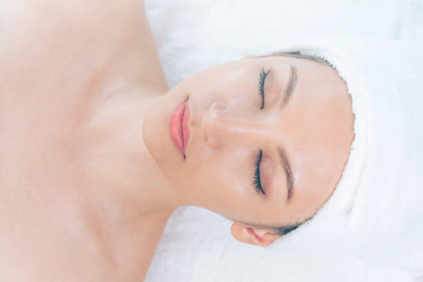 istock Relaxed young woman lying on spa bed for massage. 1011656366