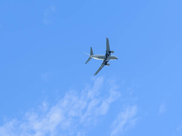 istock A modern aircraft flying high in the blue sky. 1011660356