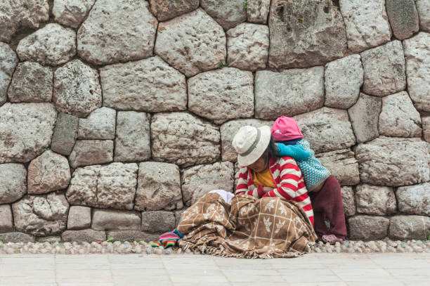 April 22, 2014 - Cusco, Peru. They are wearing colorful clothing in the city street.