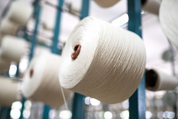 istock spindle with white yarn in the jean factory 1011665182