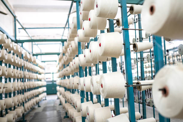 istock spindle with white yarn in the jean factory 1011665266