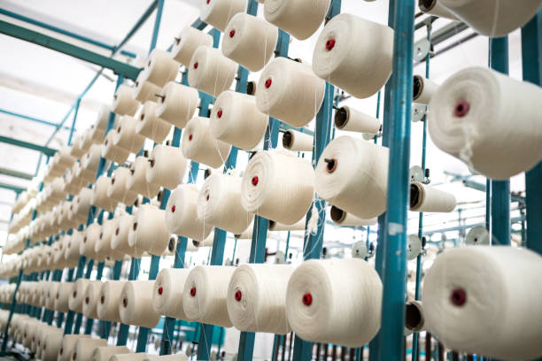 istock spindle with white yarn in the jean factory 1011665410