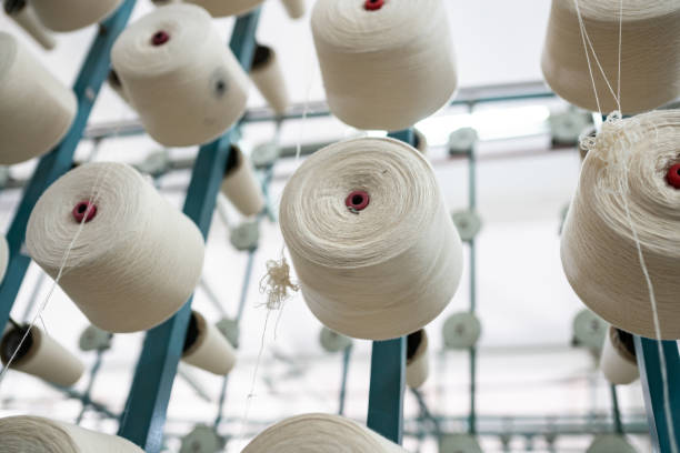istock spindle with white yarn in the jean factory 1011667496