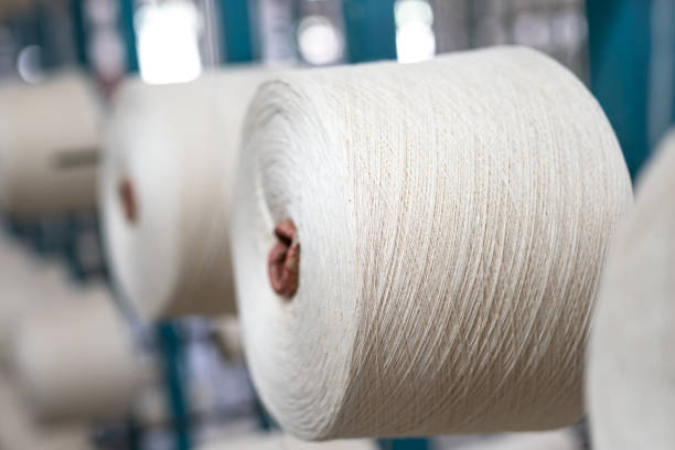 istock spindle with white yarn in the jean factory 1011667550