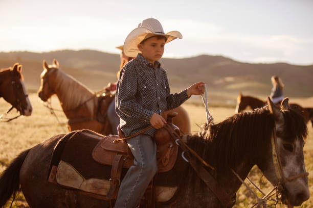 istock Little boy horseback riding 1011667552