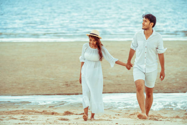 istock Happy young couple walk on the beach on honeymoon. 1011673030