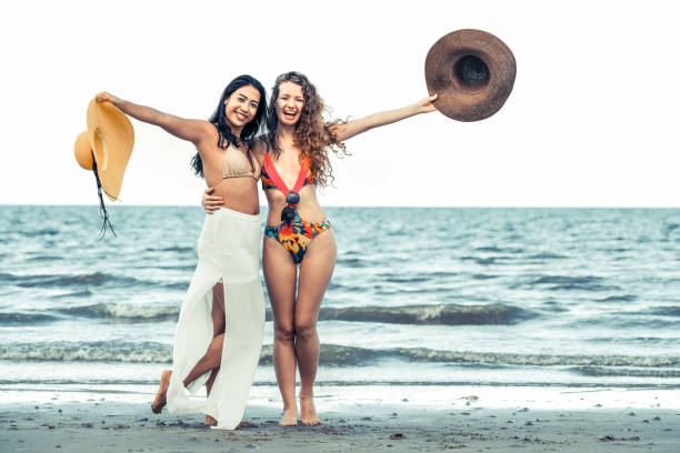 istock Happy women dance on sand beach in summer. 1011673116
