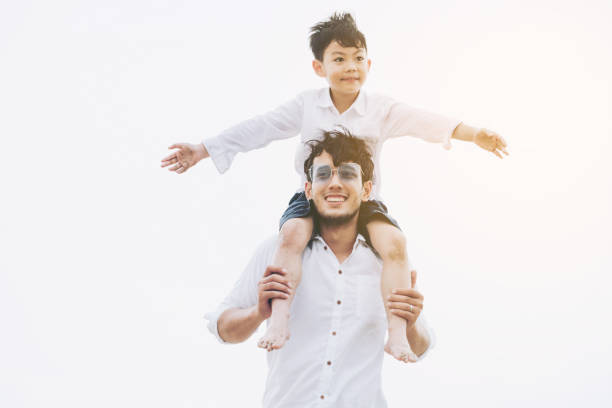istock Happy father carrying his son on the neck. 1011673174