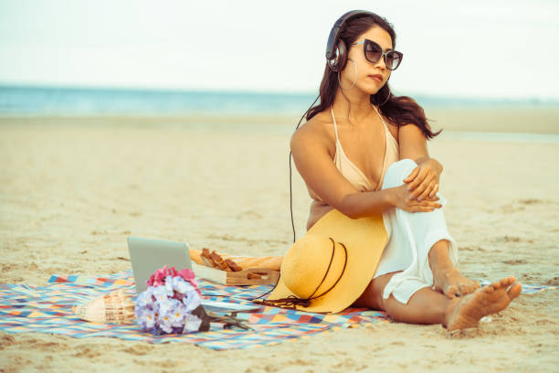 istock Plus size young woman sitting on the beach. 1011673224