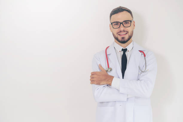 istock Young doctor with arms cross on white background. 1011675744