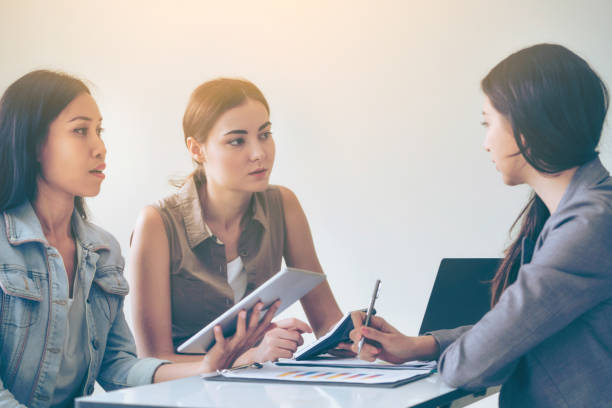istock Multicultural businesswomen in group meeting. 1011683078