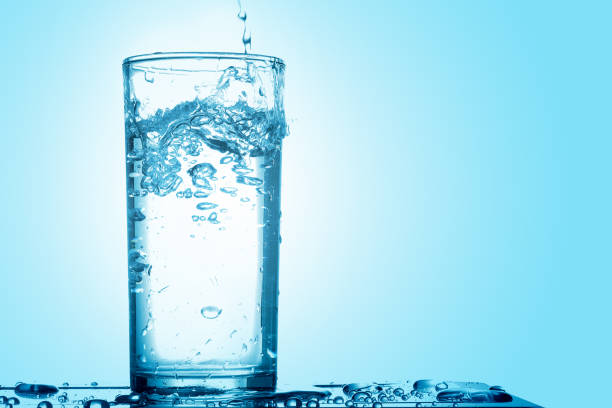 istock Pour drinking water into the glass with copy space 1011683564