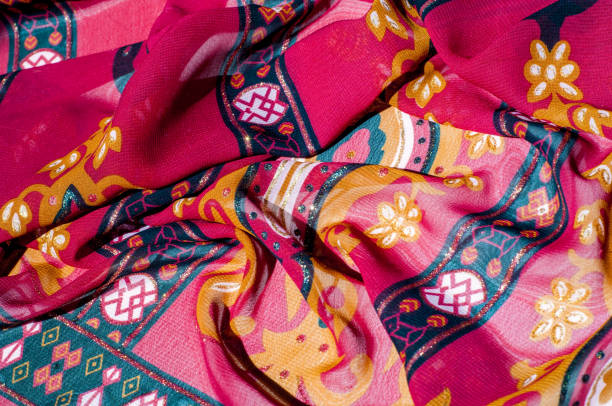 istock Background texture, pattern. Red maroon fabric. Click on your local heritage with this red, bard and yellow striped silk. This patterned fabric will decorate your design. your work will be exclusive 1011690456
