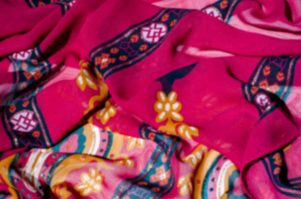 istock Background texture, pattern. Red maroon fabric. Click on your local heritage with this red, bard and yellow striped silk. This patterned fabric will decorate your design. your work will be exclusive 1011690508