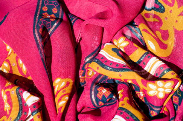 istock Background texture, pattern. Red maroon fabric. Click on your local heritage with this red, bard and yellow striped silk. This patterned fabric will decorate your design. your work will be exclusive 1011690864
