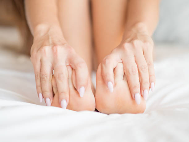 istock Female legs on the bed covered with sheets 1011696808