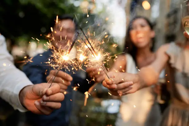 Photo of Friends with burning sparklers
