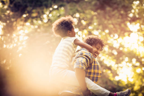 istock Kid on father piggyback. 1011699866