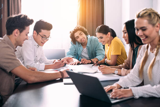 istock multiethnic group of business colleagues having discussion at table with graphs in modern office 1011709392