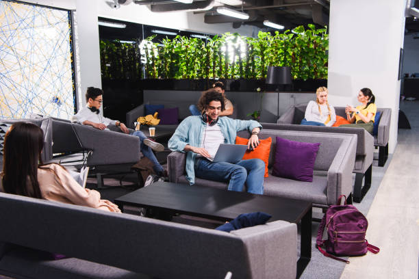 istock group of multicultural business people working and talking at modern coworking office 1011711506