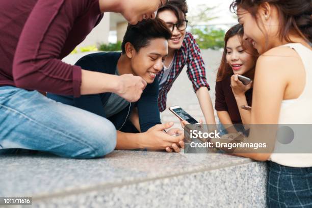 Friends Watching Funny Videos Stock Photo - Download Image Now - Asian and  Indian Ethnicities, Group Of People, Portable Information Device - iStock
