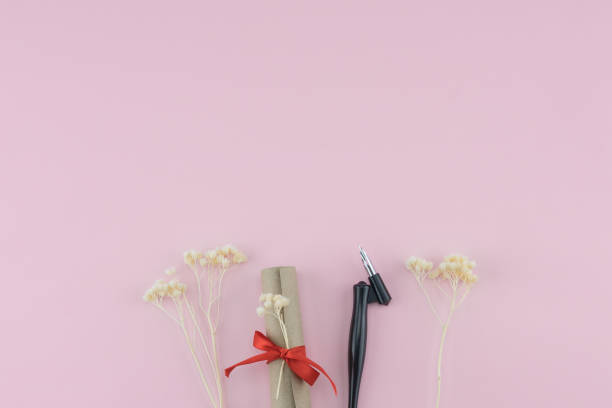 istock Scroll and oblique pen decorate with white dried flowers 1011714796