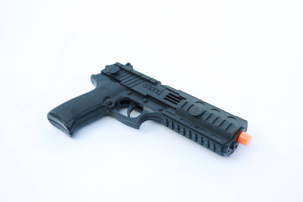 istock Black plastic toy hand gun on white background. 1011717890