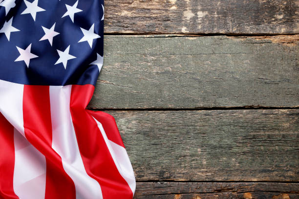 istock American flag on grey wooden table 1011721176