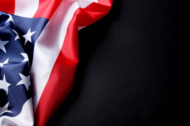 istock American flag on dark background 1011721222