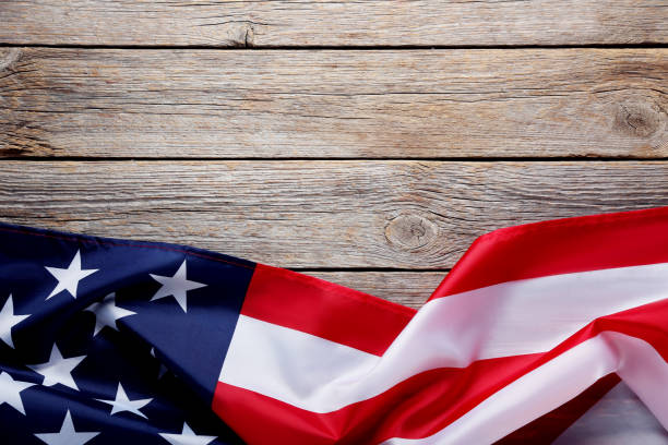 istock American flag on grey wooden table 1011724464