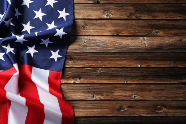 istock American flag on brown wooden table 1011724528