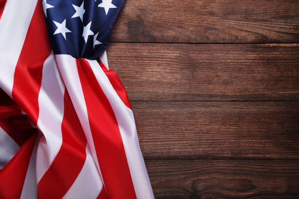 istock American flag on brown wooden table 1011725242