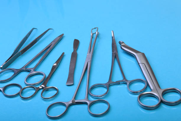 istock Close Up Surgical instruments and tools on blue mirror background. Selective focus. 1011727942
