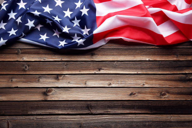 istock American flag on brown wooden table 1011728560
