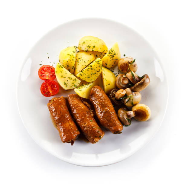 istock Beef roulade, bolied potatoes and beetroots on white background 1011728904