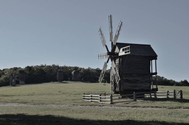 istock Large wooden windmill in the summer field 1011734178