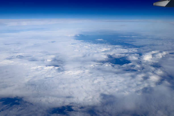 istock an Aerial view of plane window looking down to land 1011738366
