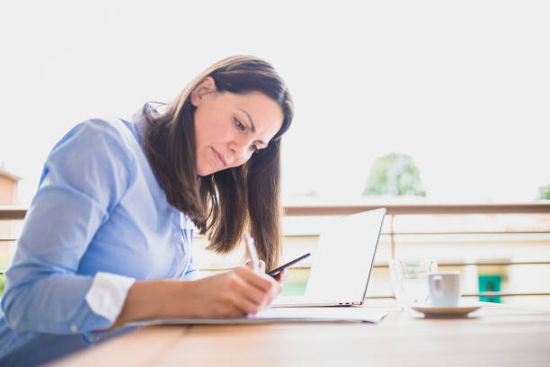 istock Young businesswomen on coffee break, using mobile phone 1011743832