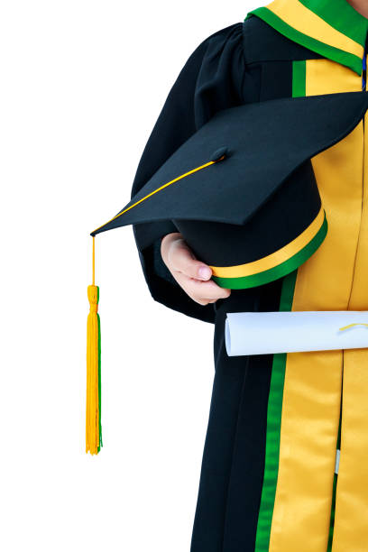 istock Child in graduation gown holding diploma certificate and cap. 1011750510
