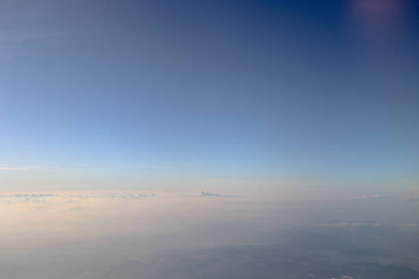 istock an Aerial view of plane window looking down to land 1011752064